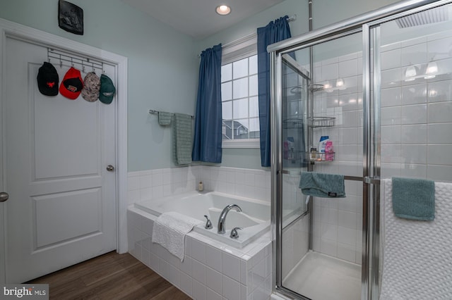 bathroom with shower with separate bathtub and hardwood / wood-style floors