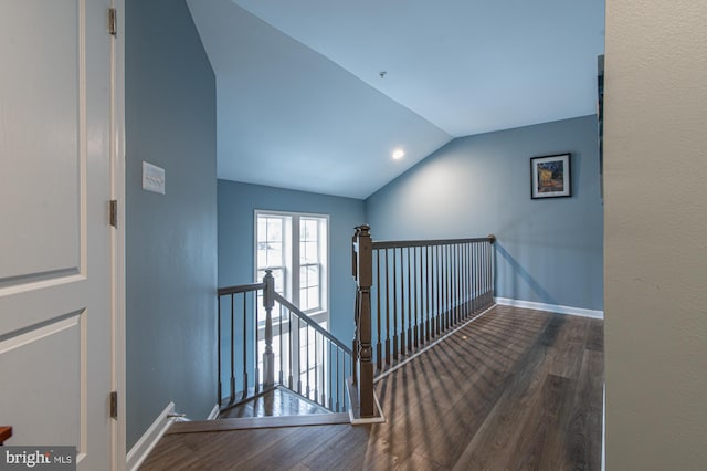 stairs featuring lofted ceiling and hardwood / wood-style floors