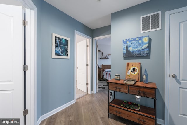 hallway with light hardwood / wood-style flooring