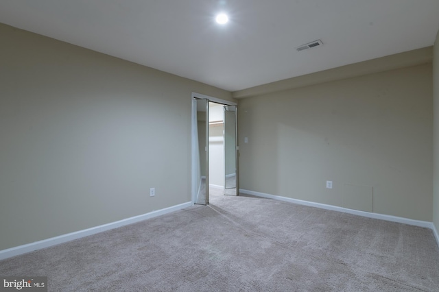 unfurnished room with light colored carpet