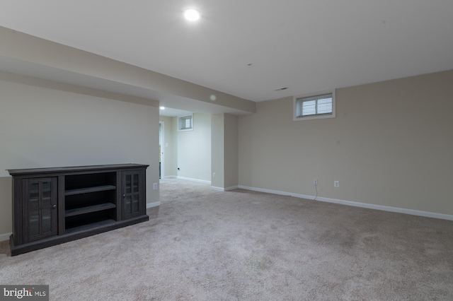 basement featuring light carpet