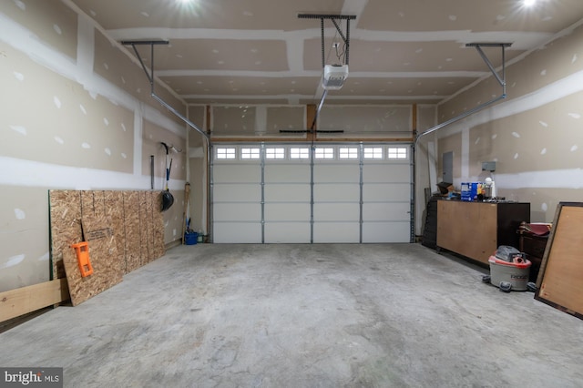 garage with a garage door opener and electric panel