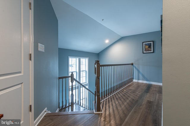 stairs with hardwood / wood-style flooring and lofted ceiling