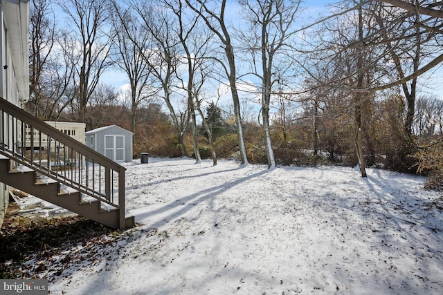 snowy yard with a storage unit