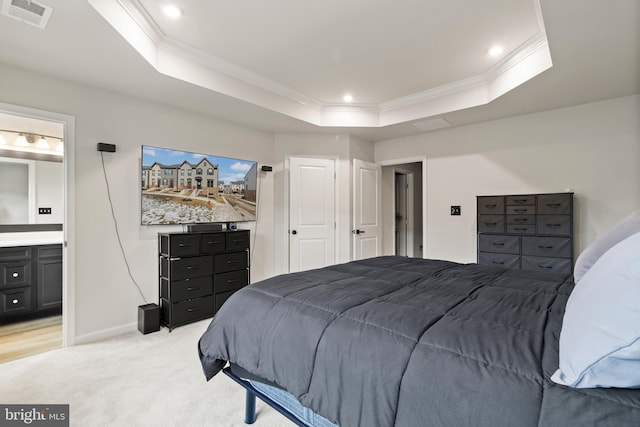 bedroom featuring light carpet, ornamental molding, connected bathroom, and a raised ceiling