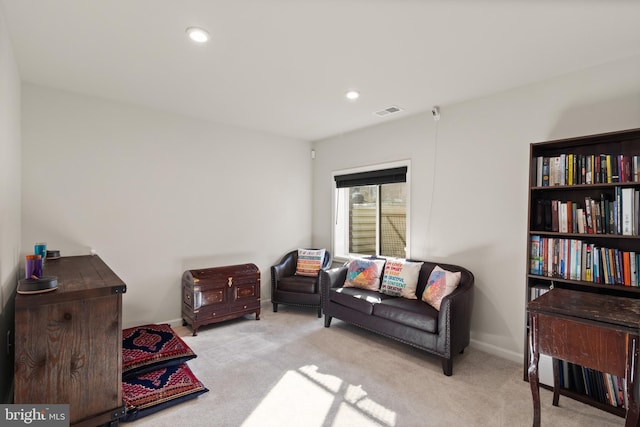 living area with light carpet