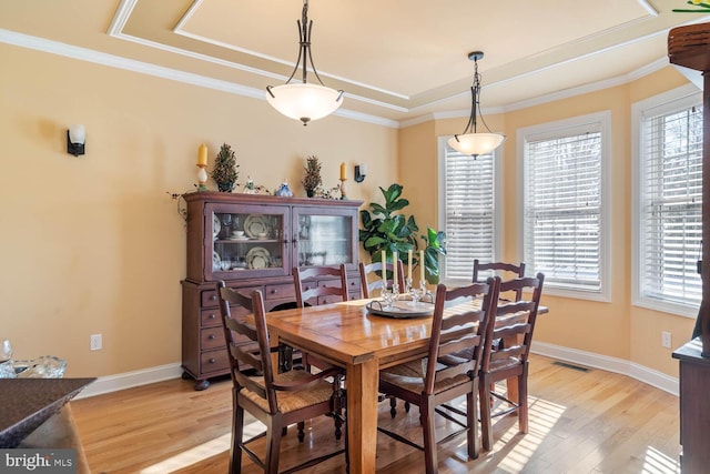 dining area featuring crown molding and light hardwood / wood-style floors