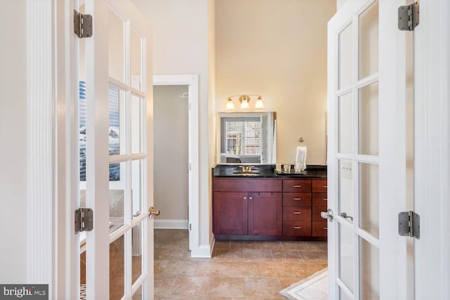 bathroom with french doors and vanity