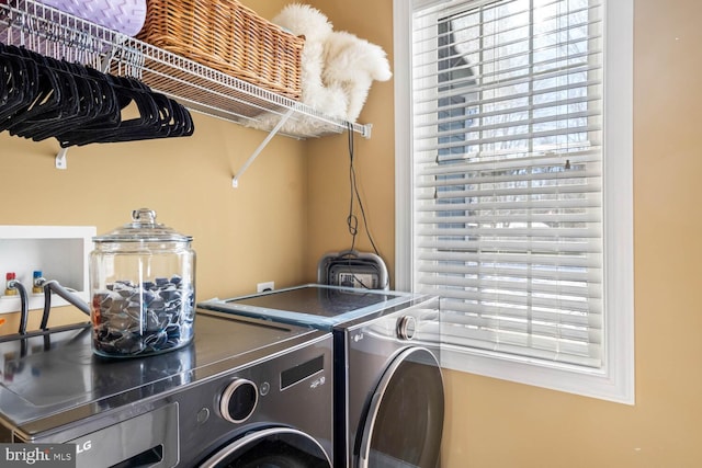 laundry room featuring independent washer and dryer and a wealth of natural light