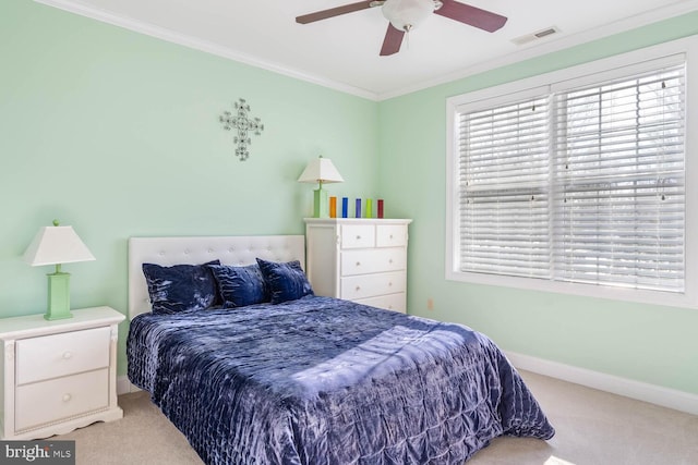 bedroom featuring crown molding, light colored carpet, and ceiling fan