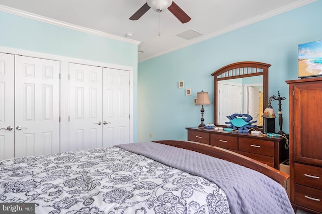 bedroom with two closets, ornamental molding, and ceiling fan