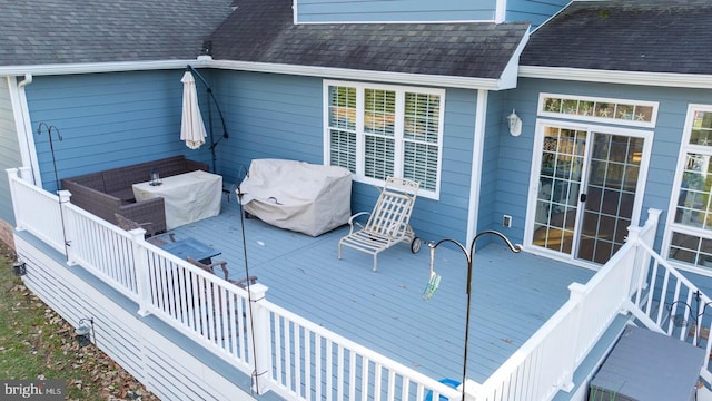 deck with area for grilling and outdoor lounge area