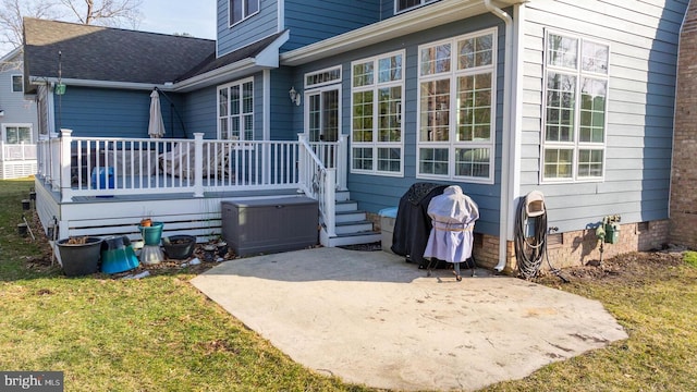 rear view of property with a patio and a lawn