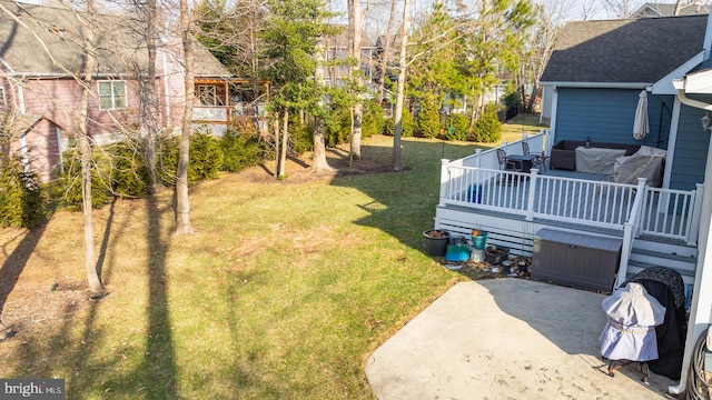 view of yard with a deck and a patio