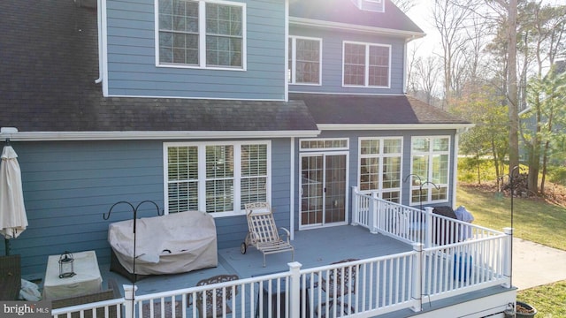 back of property with a sunroom