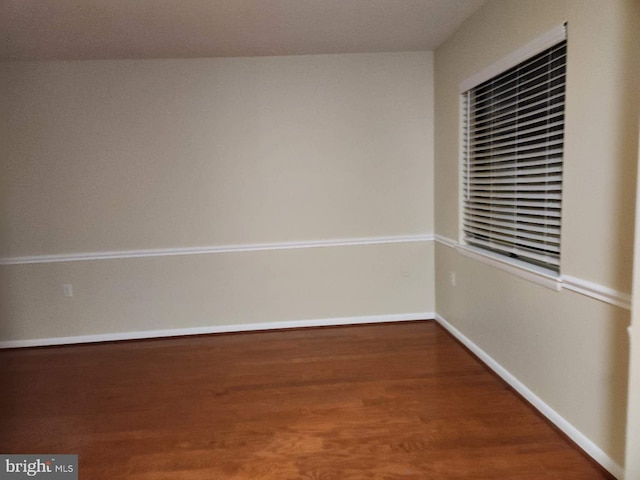 unfurnished room with hardwood / wood-style flooring