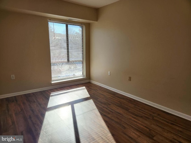 empty room featuring dark wood-type flooring