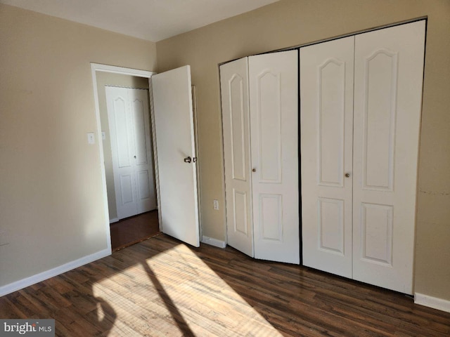 unfurnished bedroom featuring dark hardwood / wood-style floors