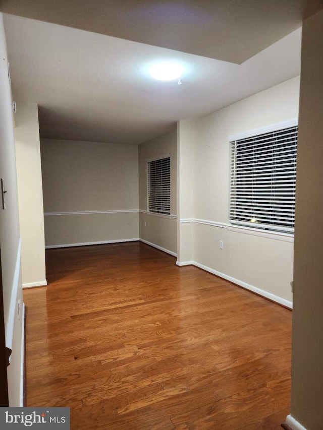 unfurnished room with hardwood / wood-style floors