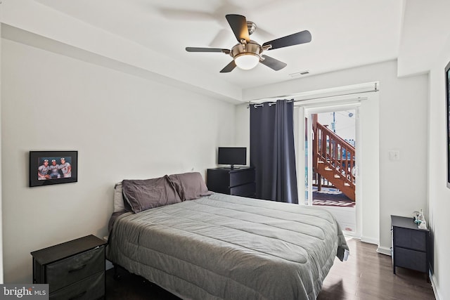 bedroom featuring ceiling fan, dark hardwood / wood-style floors, and access to exterior