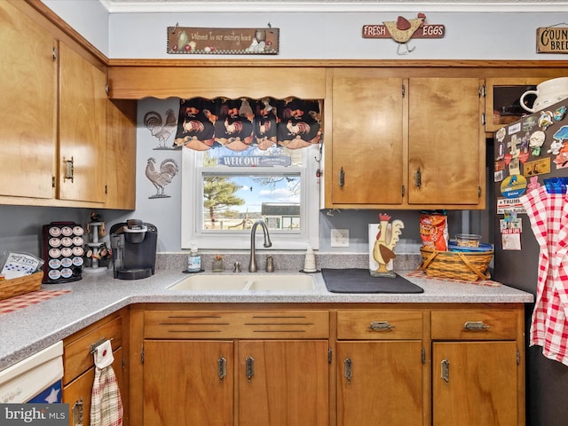 kitchen with sink, dishwasher, and stainless steel refrigerator