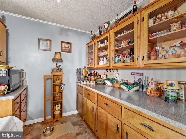 kitchen featuring a wood stove, a textured ceiling, and ornamental molding