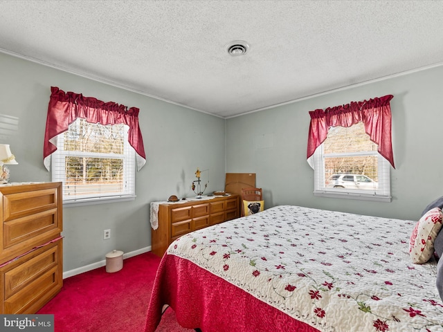 bedroom with a textured ceiling and carpet flooring