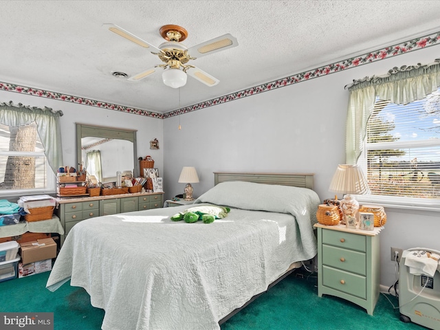 carpeted bedroom with a textured ceiling, ceiling fan, and multiple windows