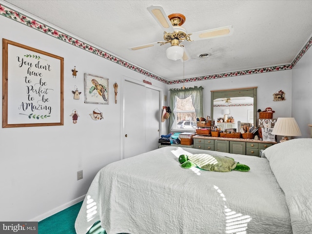 bedroom featuring a textured ceiling, a closet, carpet flooring, and ceiling fan