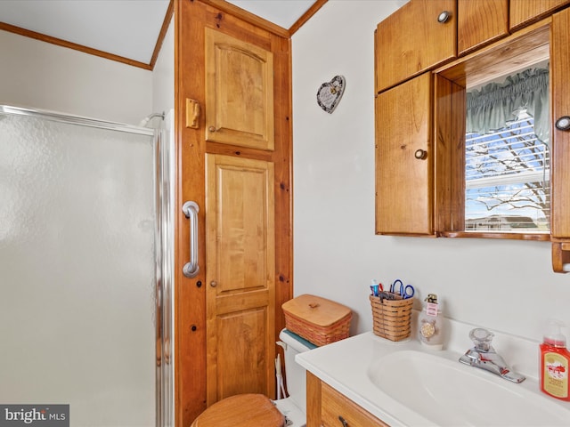 bathroom with vanity, toilet, crown molding, and walk in shower