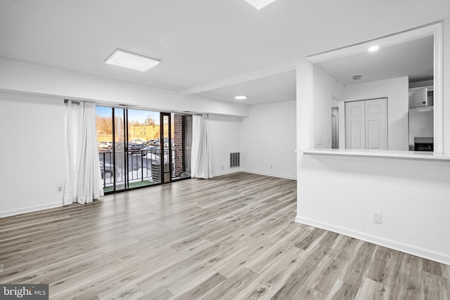 unfurnished living room featuring light hardwood / wood-style flooring