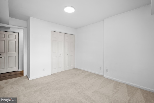 unfurnished bedroom featuring light colored carpet