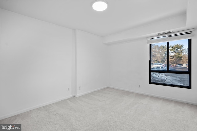 unfurnished room with light colored carpet