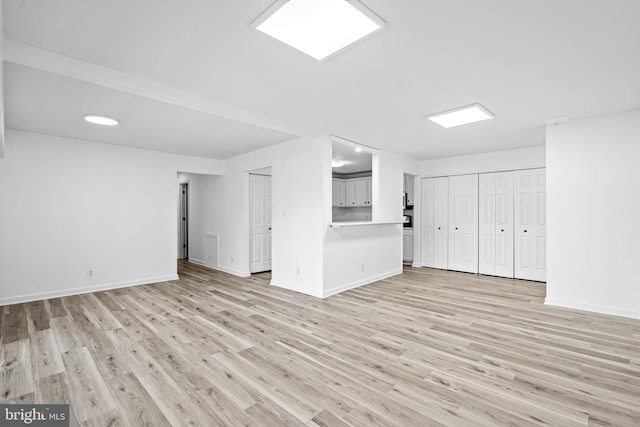 unfurnished living room with light wood-type flooring