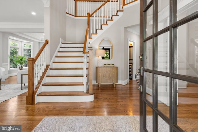 stairway featuring crown molding and hardwood / wood-style floors