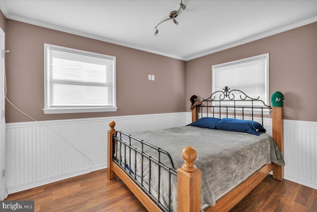 bedroom with crown molding and hardwood / wood-style floors