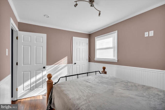 bedroom with crown molding and wood-type flooring