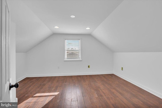 additional living space featuring dark hardwood / wood-style flooring and lofted ceiling