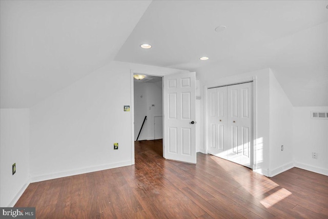 bonus room featuring lofted ceiling and dark hardwood / wood-style flooring