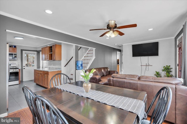 dining area featuring ceiling fan and ornamental molding