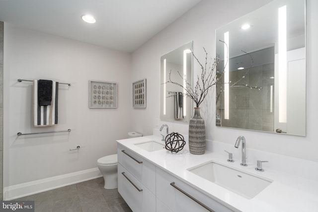 bathroom with toilet, double vanity, a sink, and tiled shower