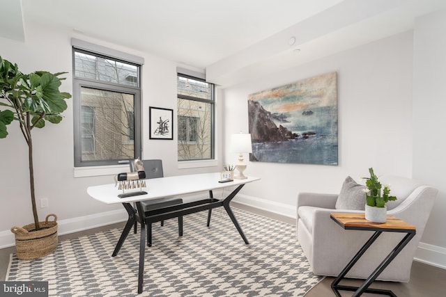 home office featuring wood finished floors and baseboards