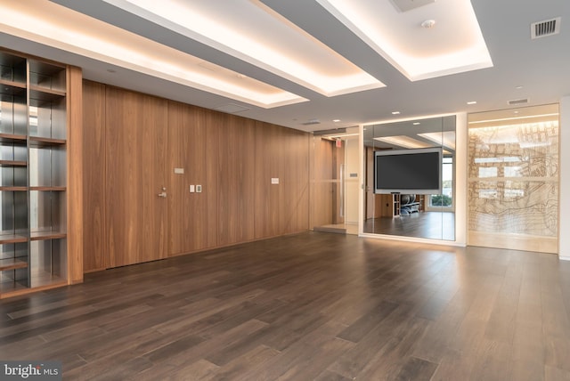 interior space featuring wood walls, visible vents, and wood finished floors