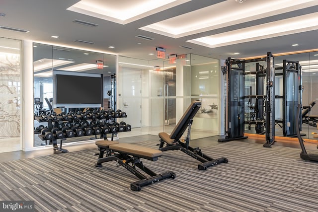 exercise room featuring carpet floors and visible vents