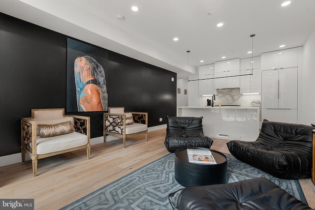 living room with sink and light wood-type flooring