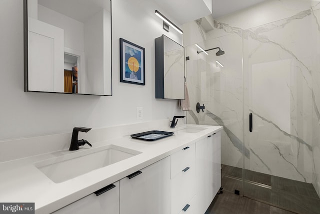 bathroom featuring an enclosed shower and vanity