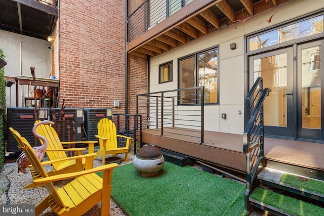 wooden deck featuring cooling unit