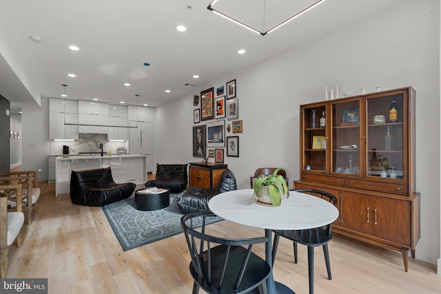 dining area featuring sink and light hardwood / wood-style flooring