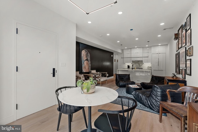 dining area featuring sink and light hardwood / wood-style floors