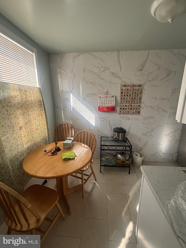 dining area with light tile patterned floors